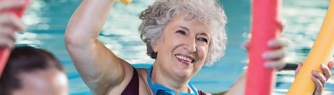 Older woman exercising in a Water Aerobics class