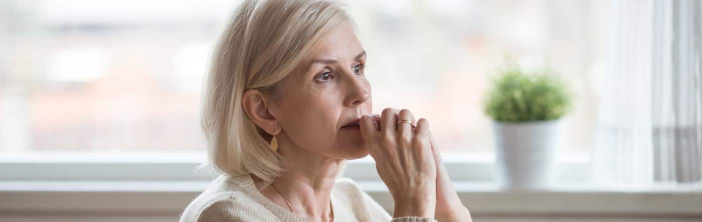 Mental Health and Aging in Seniors. Older lady looking off into the distance.